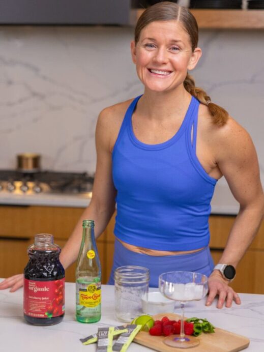 woman in her kitchen with LMNT electrolytes, tart cherry juice and sparkling water to make a sleepy girl mocktail