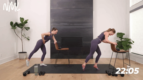 two women performing a releve rear leg lift in a barre workout