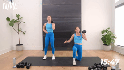 two women performing a single arm press in a full body workout for women