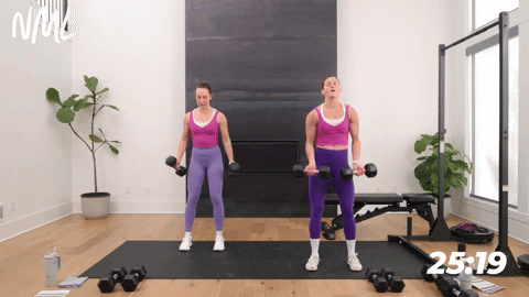 two women performing flip grip bicep curls with dumbbells in a back and bicep workout