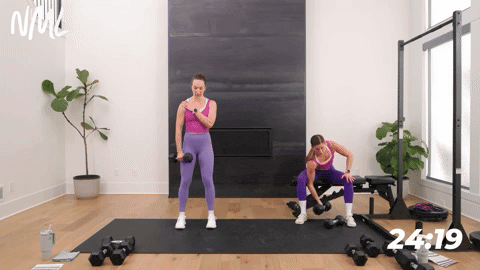 two women performing single arm concentration curls in a back and bicep workout