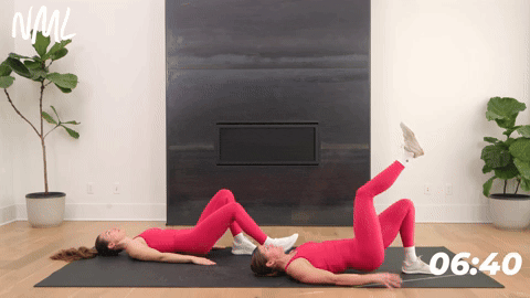 one woman performing a single leg glute bridge and one woman performing a staggered glute bridge in a core workout for runners