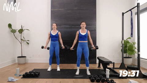 two women performing bicep curls in a back and bicep workout