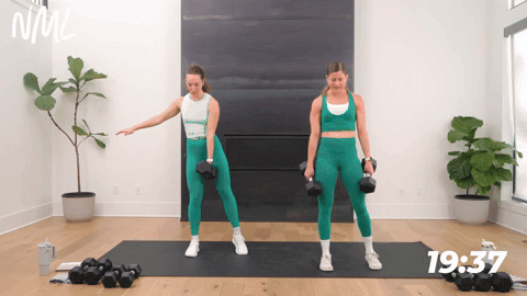 two women performing curtsy lunges with dumbbells in a leg and glute workout