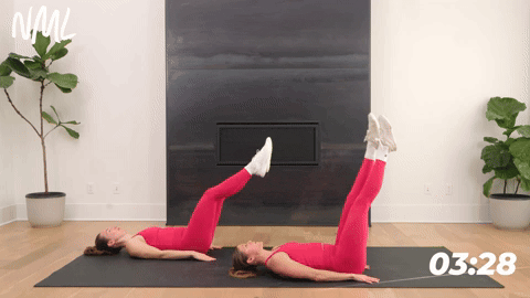 one woman performing lying leg raises and one woman performing lying leg kick outs in a core workout for runners