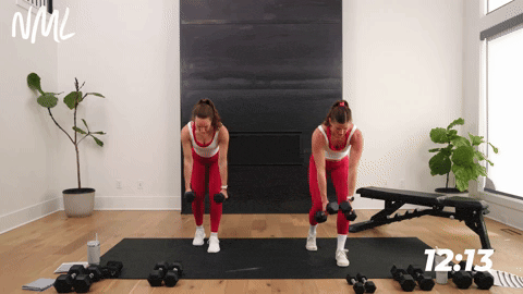 two women performing straight arm pullbacks with dumbbells in a chest shoulders and triceps workout