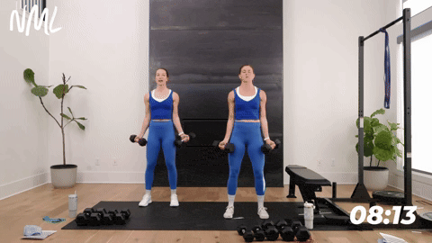 two women performing wide bicep curls in a back and bicep workout