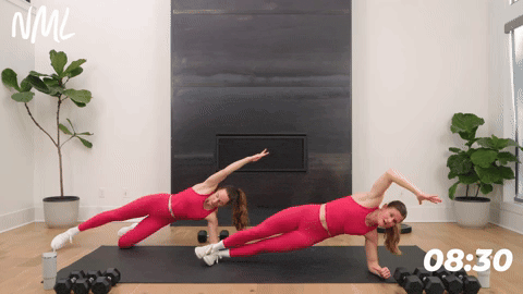 two women performing a side plank in a strength workout for runners