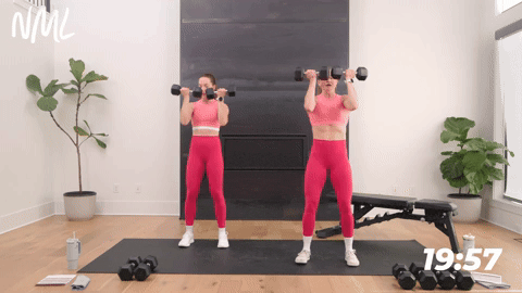 two women performing an arnold press | push day chest shoulders triceps workout