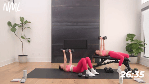 one women performing a chest fly on the ground and another doing chest fly on a bench | push day chest shoulders triceps workout