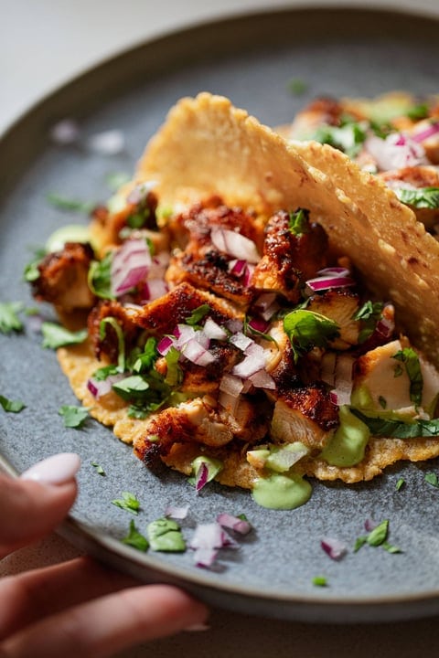 Chicken tacos made with chicken thighs, taco seasoning, cheese, soy sauce, garlic 