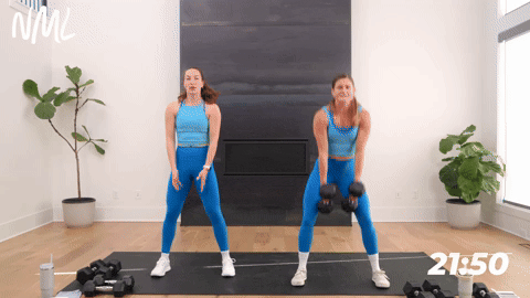 two women performing slow dumbbell burpees; a squat, high plank and push up