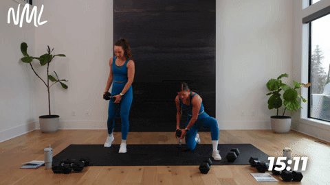 One women performing a half kneeling chop and one women performing a standing kneeling chop