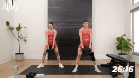 Two women performing a weighted sumo deadlift