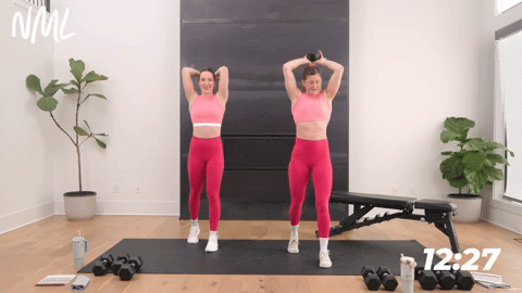 two women performing a overhead tricep extension
