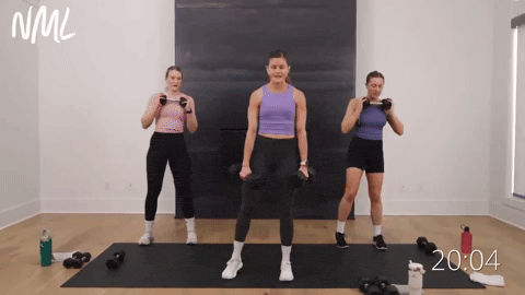 three women performing curtsy lunges in a dumbbell leg workout