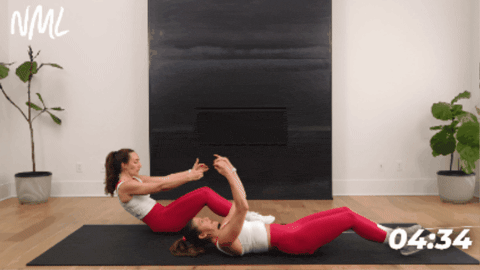 women showing how to perform pilates roll up as part of deep core workout