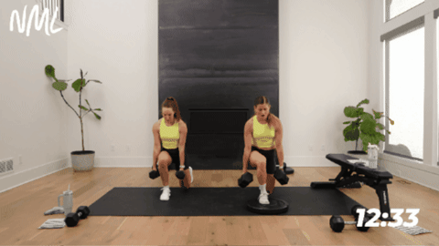 women demonstrating a deficit lunge with one heel elevated 