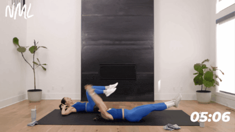 woman laying on their backs performing reverse crunches
