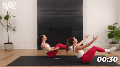 2 women performing roller boat exercise to engage deep ab muscles