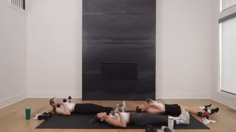 three women performing a sprinter sit up and dumbbell press in an upper body workout