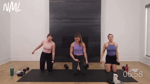 three women performing an uneven prisoner get up in a leg workout