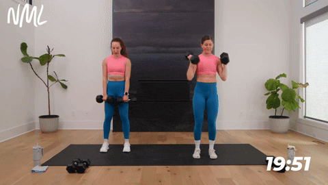 two women performing a lunge clean squat thruster in a full body hiit workout