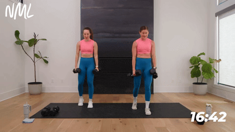 two women performing a deadlift bicep curl in a full body hiit workout