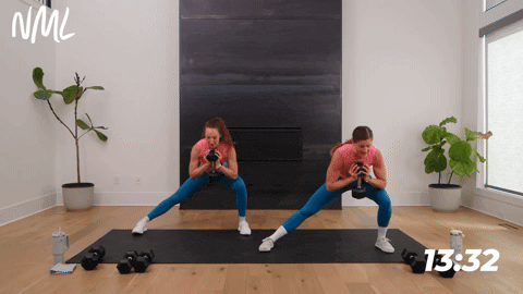 two women performing a lateral squat and knee drive in a full body hiit workout