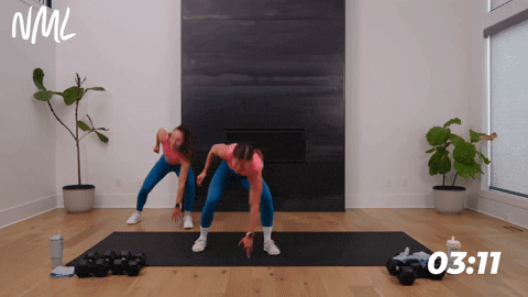 two women performing lateral shuffles in a full body hiit workout