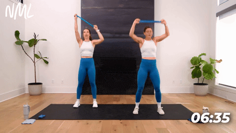 Two women performing a Face Pull with a resistance band.