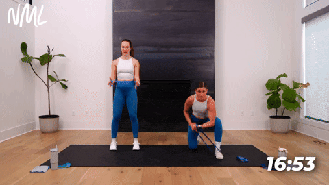 One women performing a Kneeling Concentration Curl with a resistance band. One Women performing standing bicep curls with a resistance band.