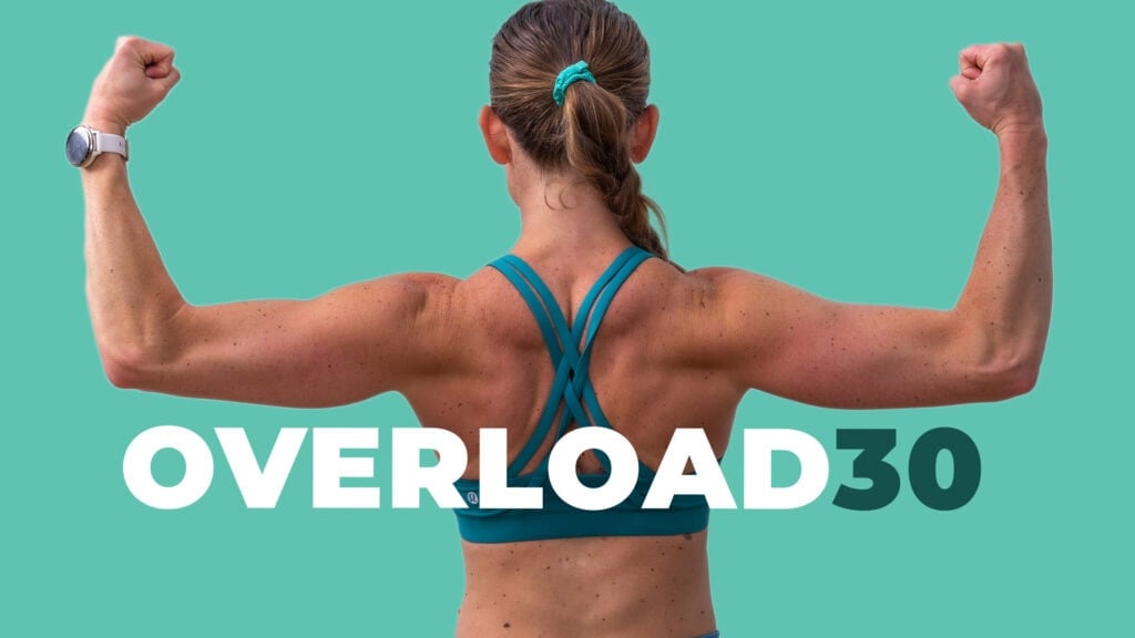 woman flexing to show off strong arms after completing progressive overload program