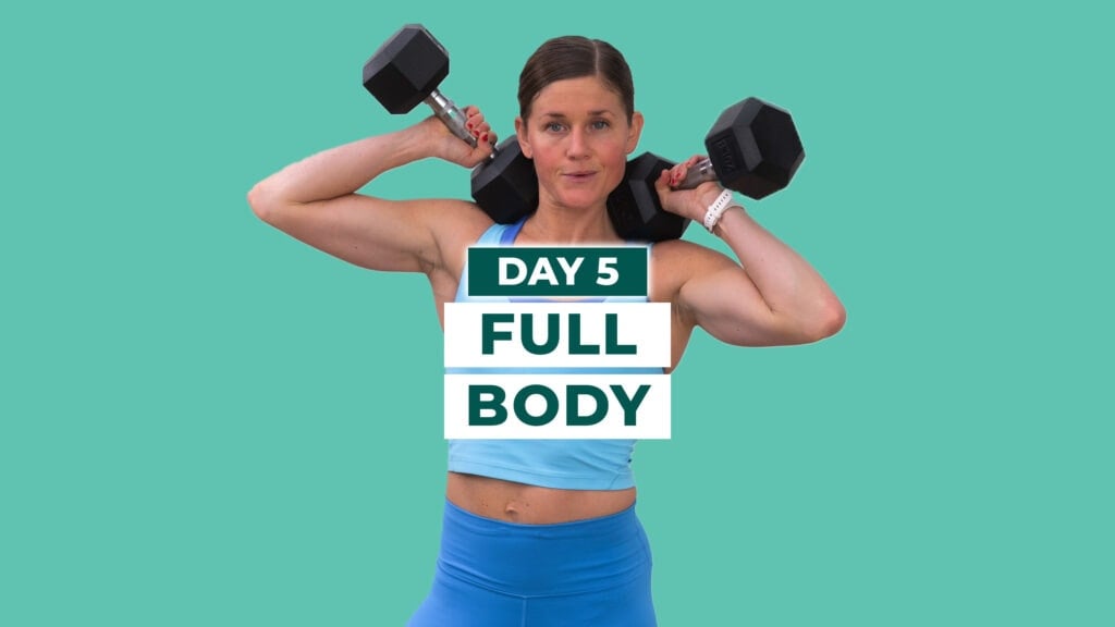 Woman holding dumbbells after completing full body overload workout