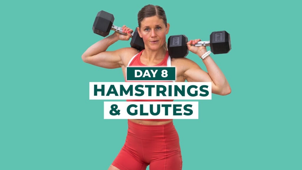 Woman holding dumbbells at shoulders after completing glutes and hamstrings workout