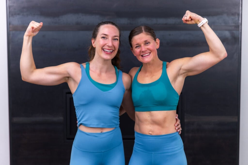 two women flexing after completing progressive overload workout plan