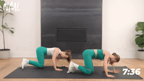 two women performing fire hydrant kicks as part of ab and butt workout