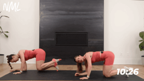 women performing a fire hydrant with a leg extension as part of pilates mat workout
