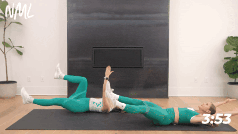 woman laying on ground demonstrating full body crunch