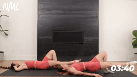 women performing a single leg glute bridge with a leg lift
