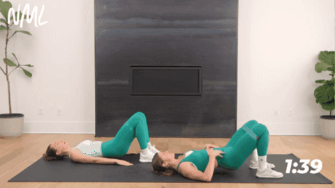 demonstrating of glute bridge to target glutes and abs
