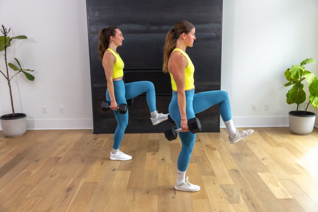 two women performing walking lunges in a hyrox workout