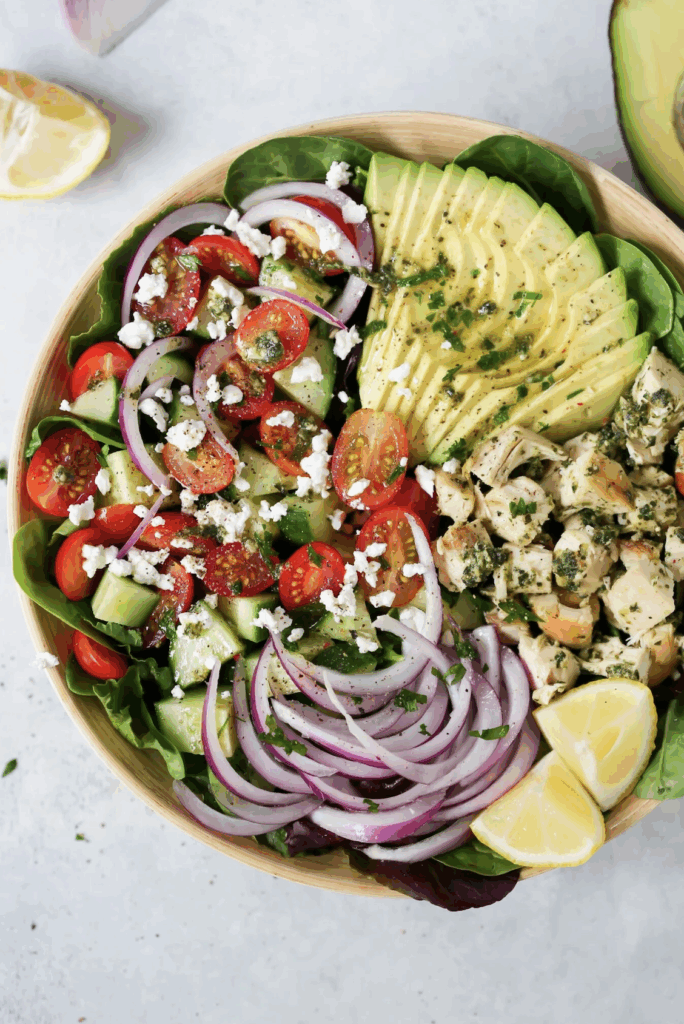 Pesto Chicken Salad with chicken, cucumber, tomato, onions, avocado and lettuce.