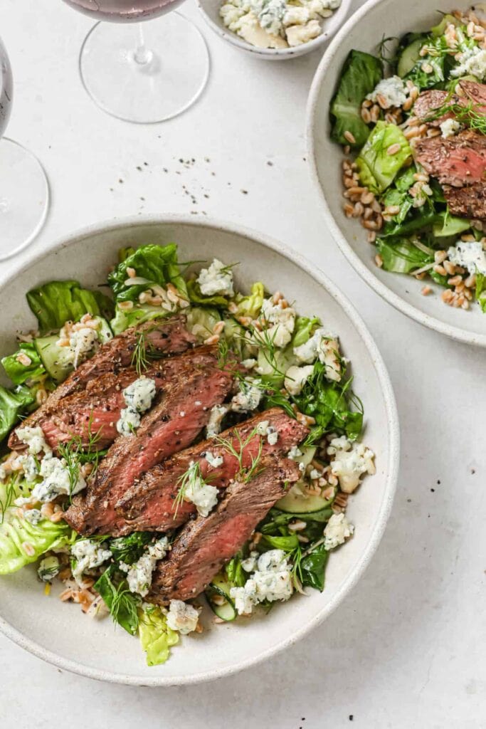 Steak and Farro Salad with lettuce and blue cheese crumbles.