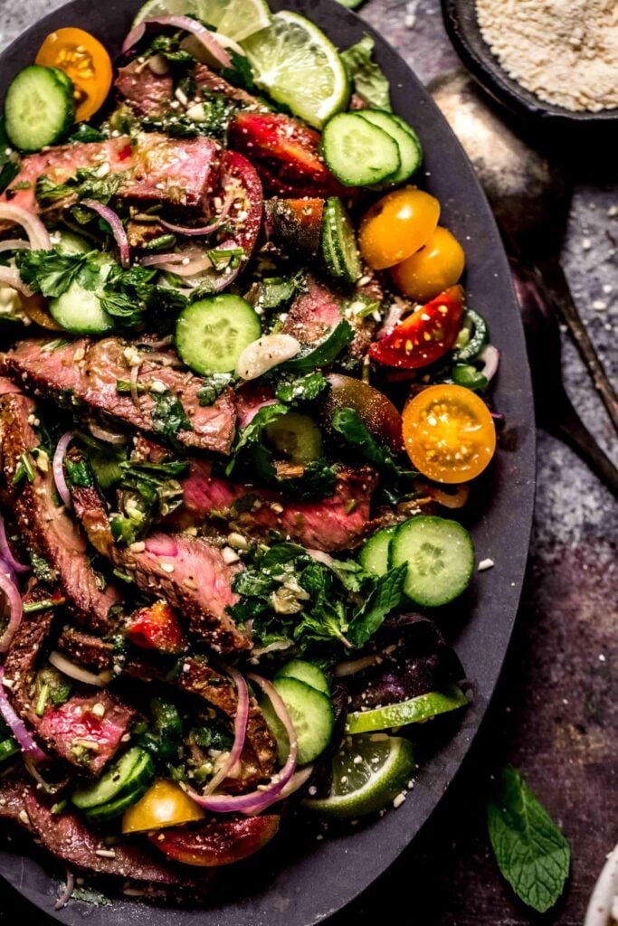 Thai Beef Salad with lettuce, cucumbers, onions and tomatoes.