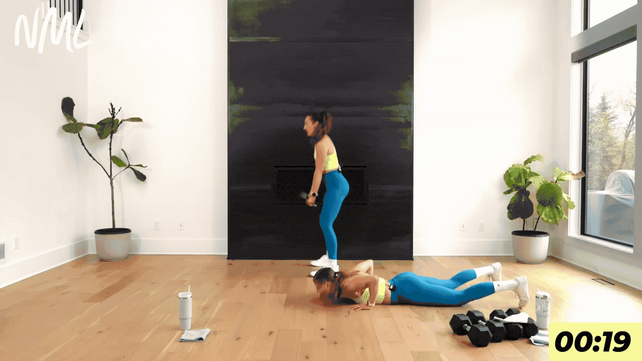 two women performing broad jumps as part of hyrox workout 