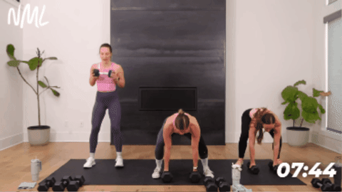 women performing a push up and burpee with dumbbells as part of full body workout 
