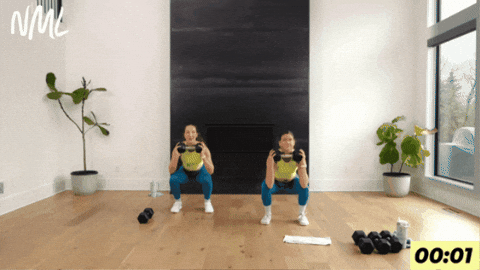 women demonstrating squat thrusters as part of hyrox workout