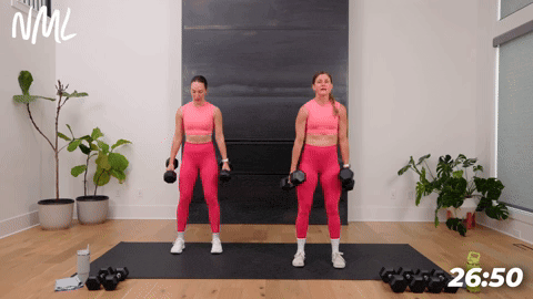 two women performing dumbbell squats in a full body strength and conditioning workout
