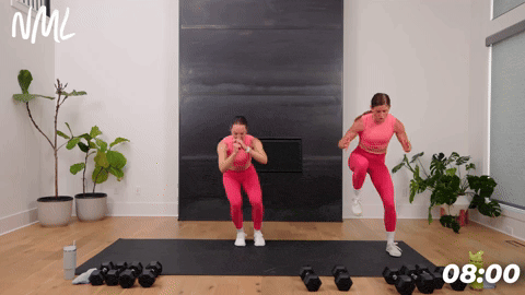two women performing lateral bounds in a full body strength and conditioning workout